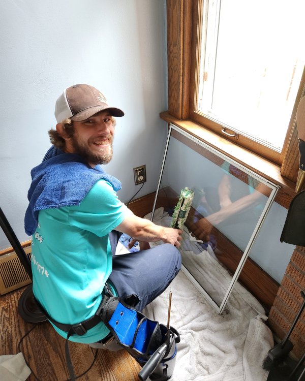 Miciah inside home performing a window cleaning service