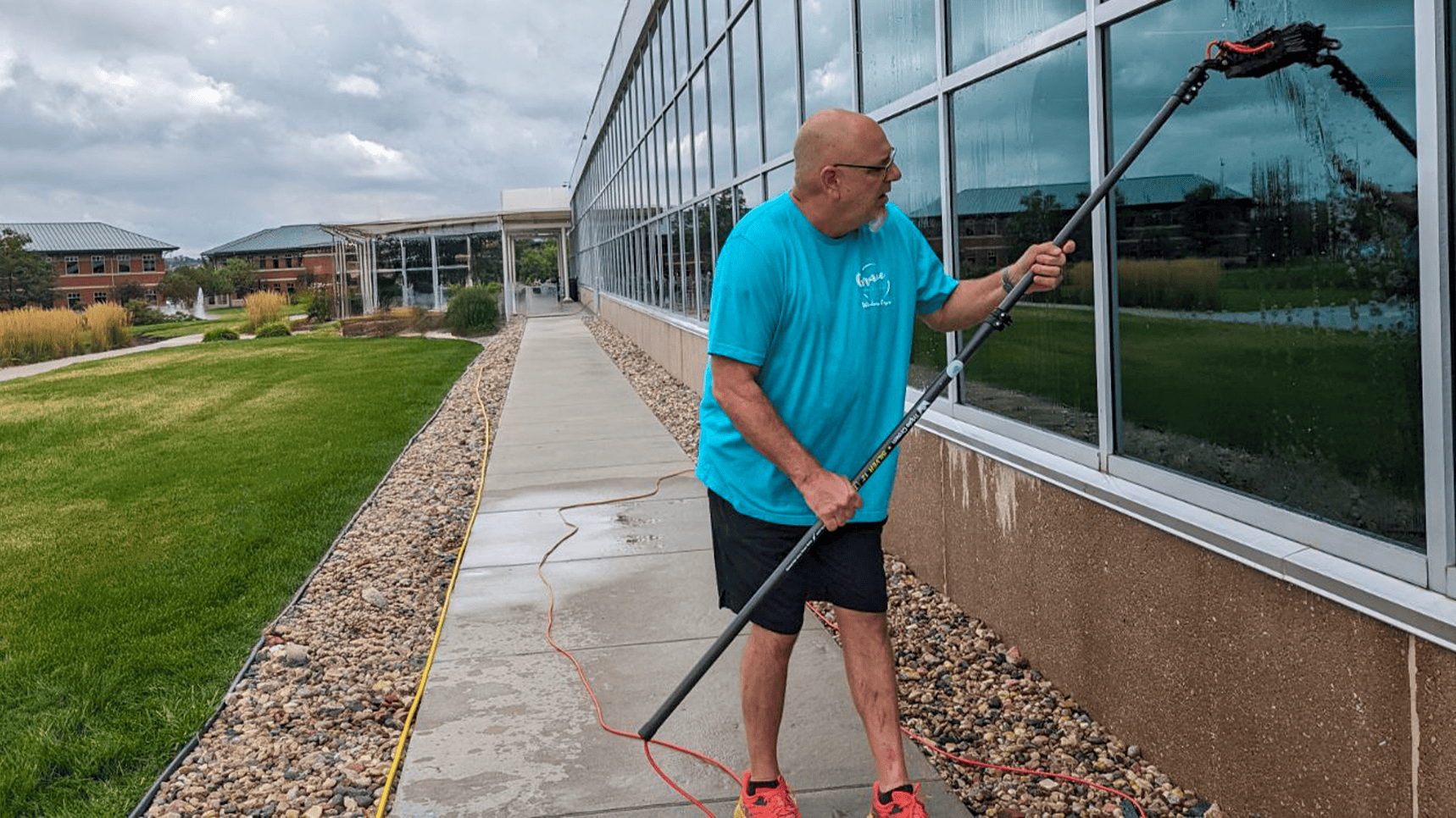 Founder Kevin Smith of Grace Window Cleaning working on a commercial window project